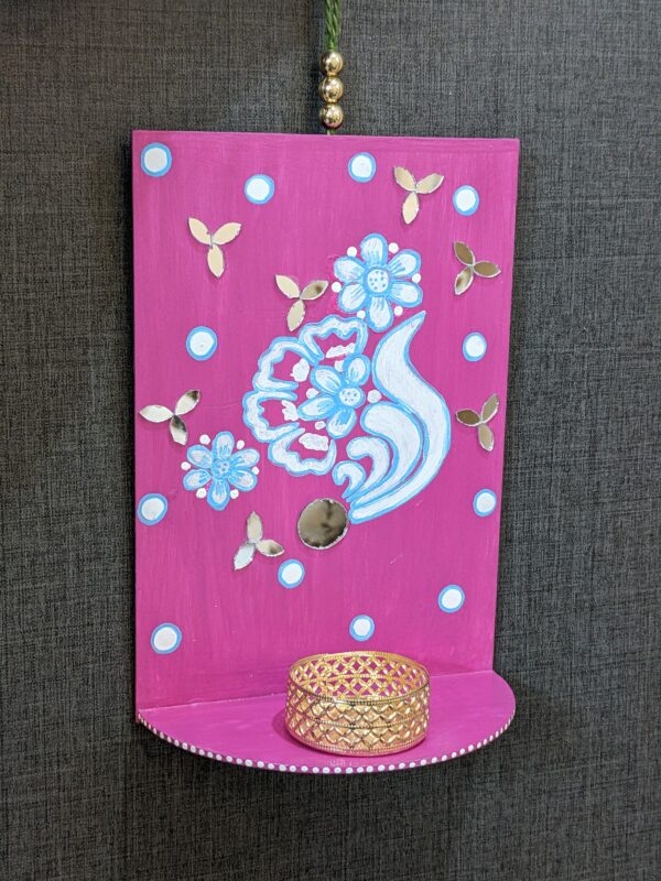 Pink T-light holder on wall hanging